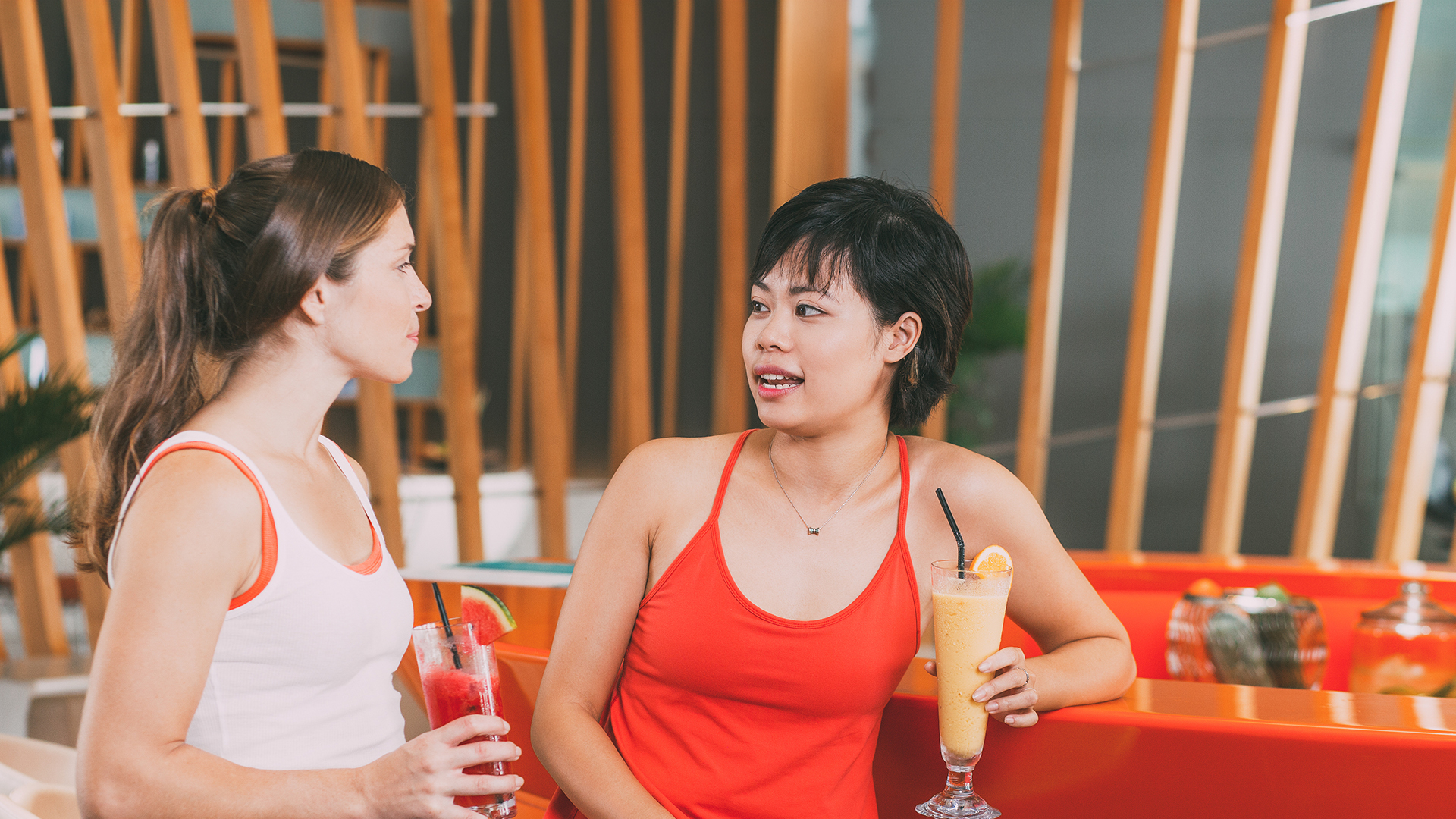 Pickleball players socializing and having drinks at an indoor club bar